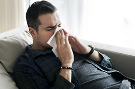A man blowing his nose.