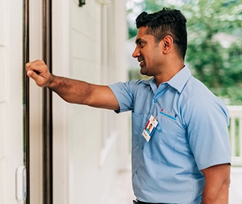 Aire Serv technician infront of door.