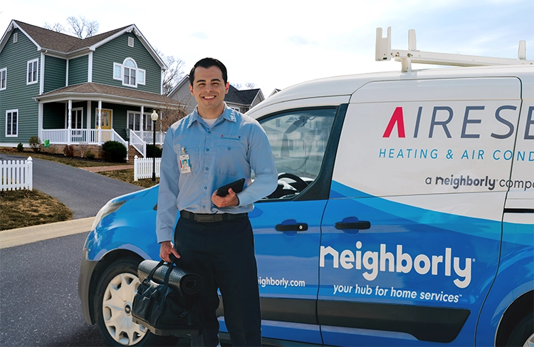  Aire Serv tech standing by his van before a furnace maintenance appointment 