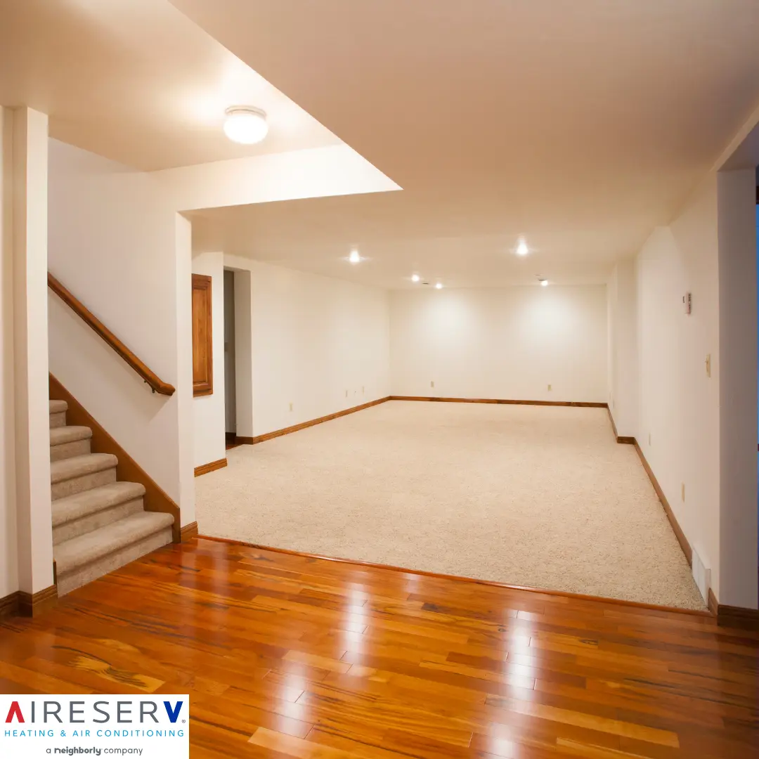 A walkout basement with a mix of carpeted and hardwood flooring, bright recessed lighting, and a staircase leading to the upper level.