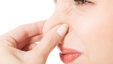 Woman holding nose